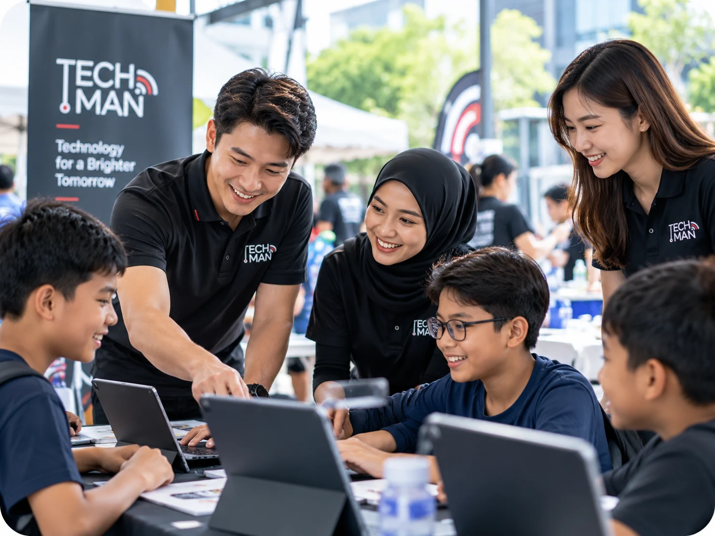 Techman volunteers guiding youth in a community technology workshop